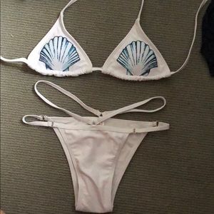 white swim suit with seashells on the top.